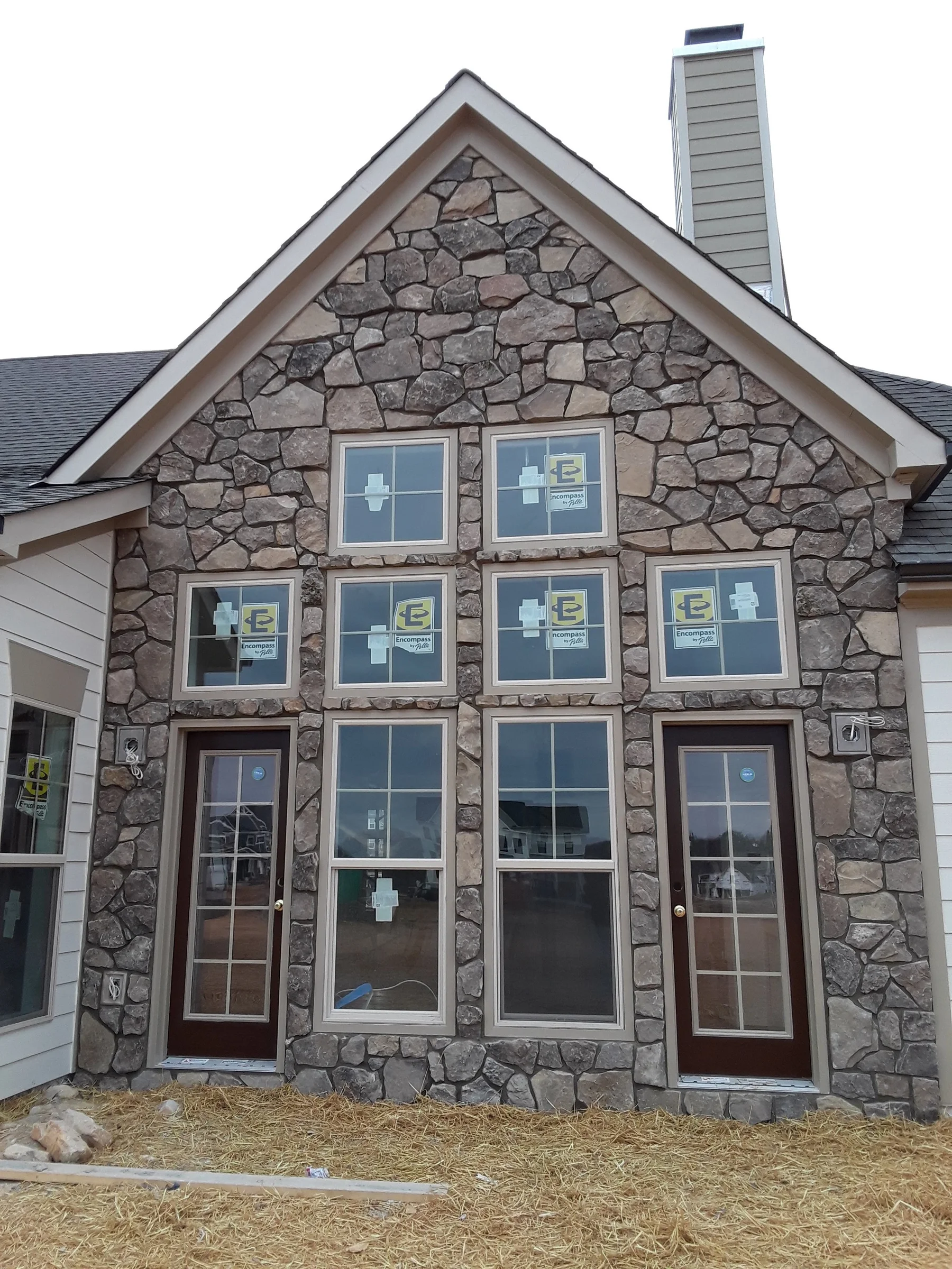 Completed multi-window stone house front