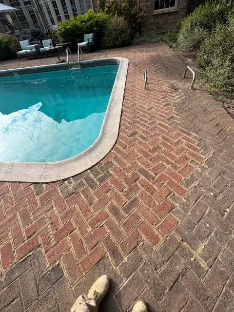 Brick pool deck before repair