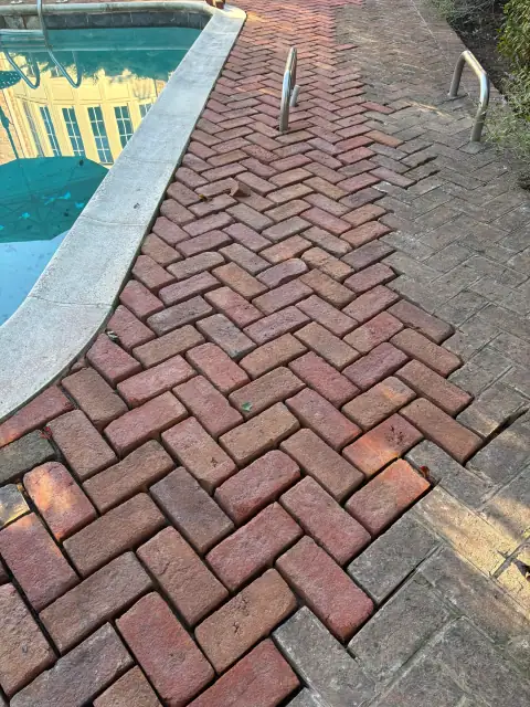 Brick pool deck being repaired