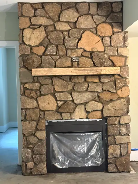 Indoor natural stone fireplace by F. Stone Designs