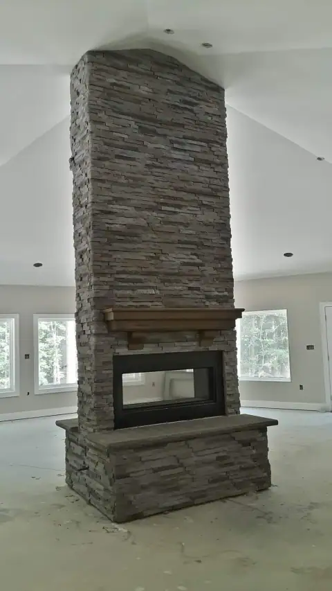 Indoor natural stone fireplace by F. Stone Designs