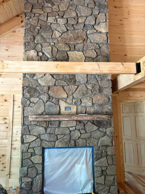 Indoor natural stone fireplace by F. Stone Designs