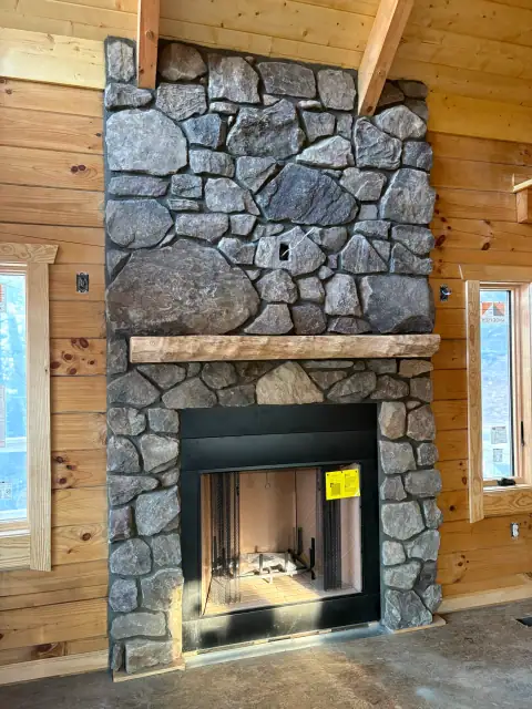 Indoor natural stone fireplace by F. Stone Designs