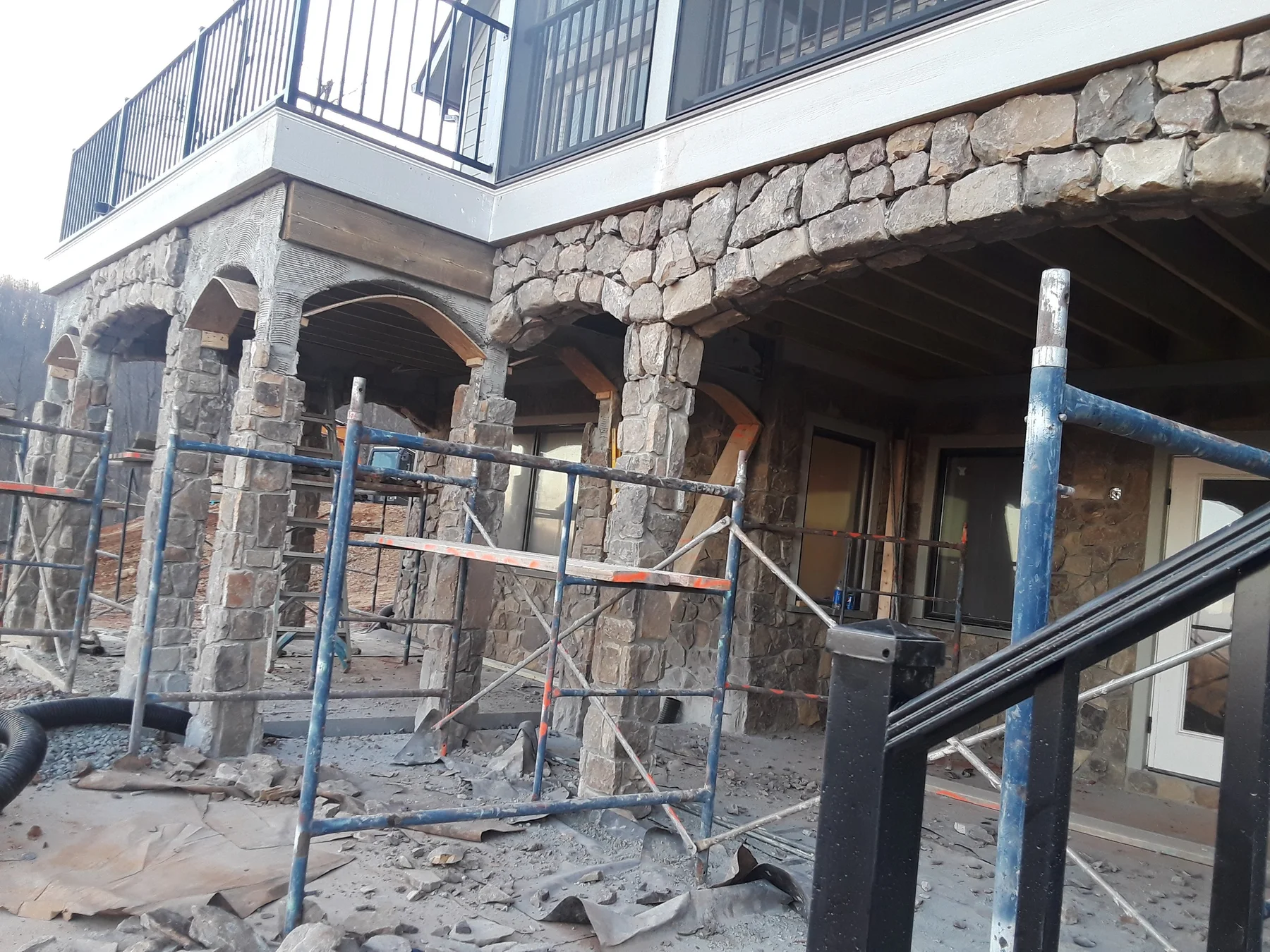 Stone columns and arches along the lower terrace of a home