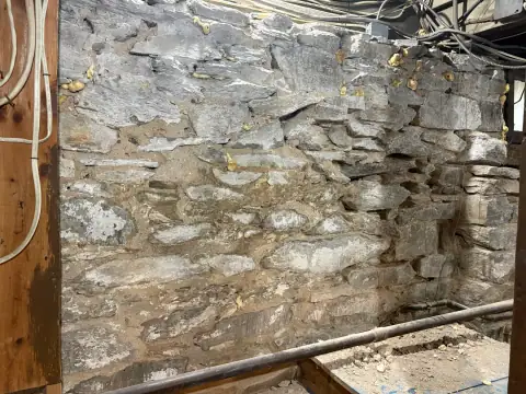 Stone foundation corner prepared for masonry restoration