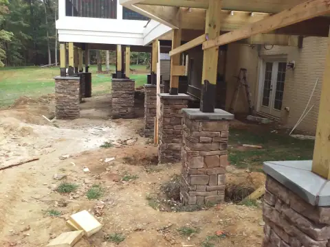 Multiple stone columns during covered patio construction