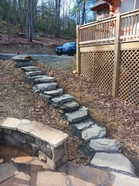 Stone garden steps beside a deck and flagstone patio by F. Stone Designs