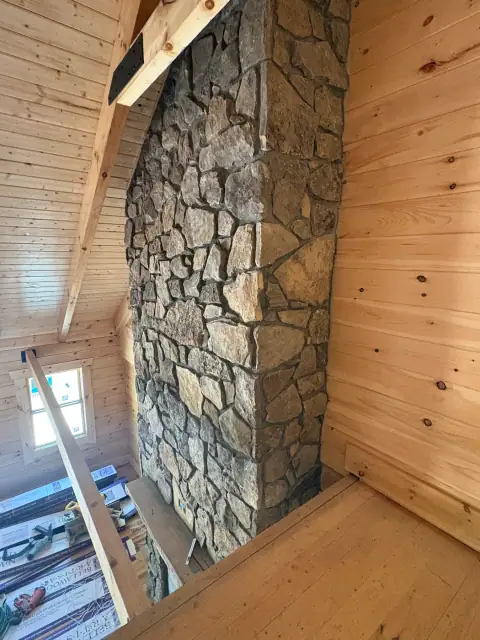 Indoor natural stone fireplace by F. Stone Designs