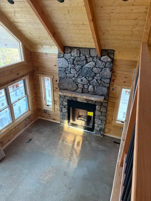 Indoor natural stone fireplace by F. Stone Designs