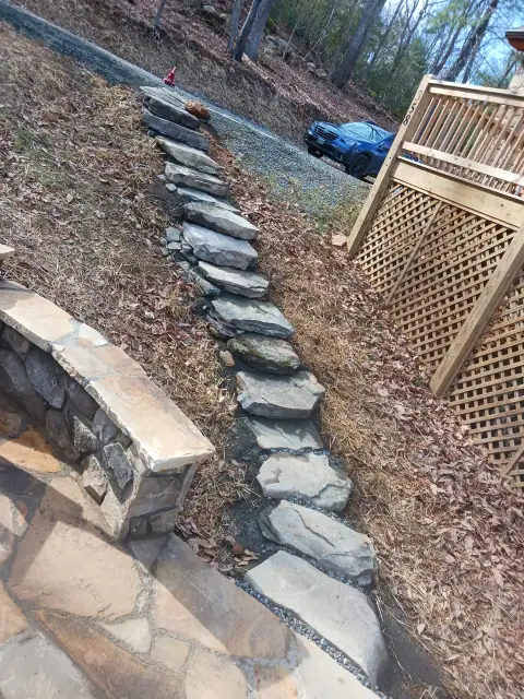 Natural stone stepping path connecting a patio and deck by F. Stone Designs
