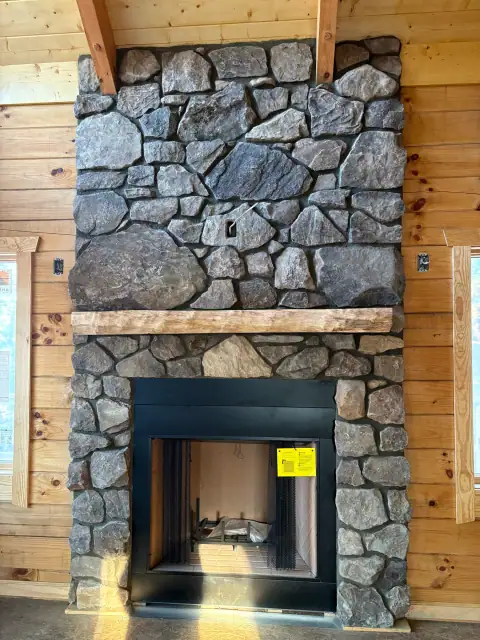 Indoor natural stone fireplace by F. Stone Designs