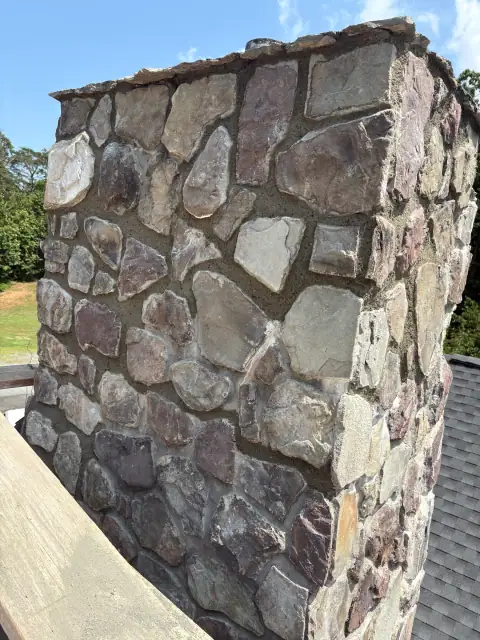 Stone chimney masonry repair view two