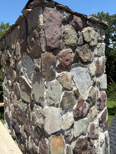 Stone chimney masonry repair view three