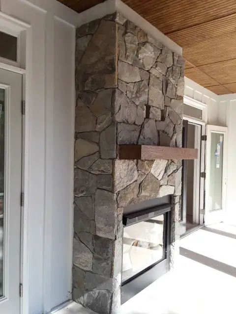 Indoor natural stone fireplace by F. Stone Designs