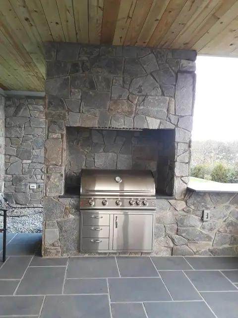 Completed outdoor stone kitchen with built-in grill
