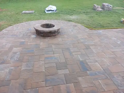 Outdoor stone fire pit and patio by F. Stone Designs